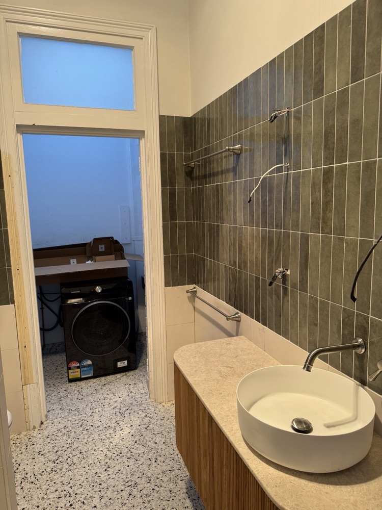 Bathroom and laundry renovation with vanity, tiling and terrazzo floor