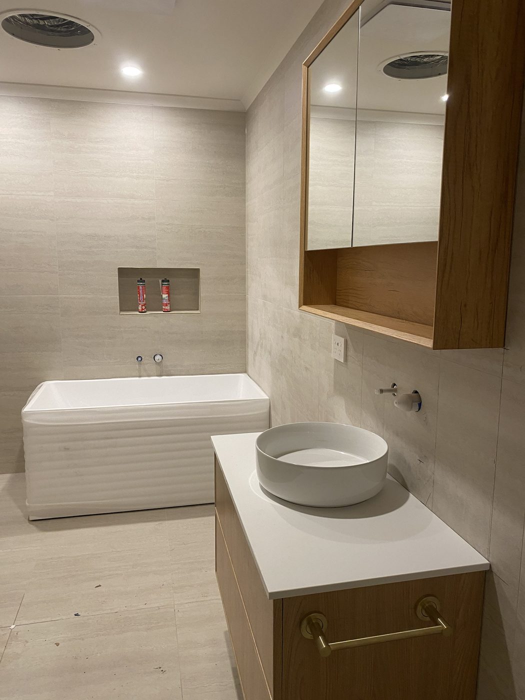 Renovated bathroom with timber vanity and vessel basin