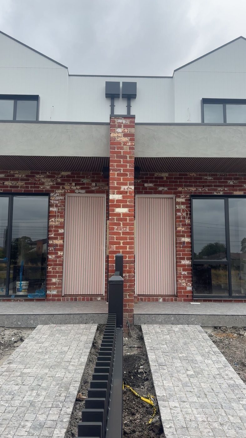 New build facade in face brick with white cladding above
